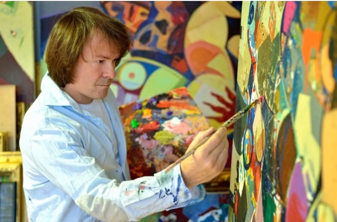 Igor Tcholaria painting in his studio